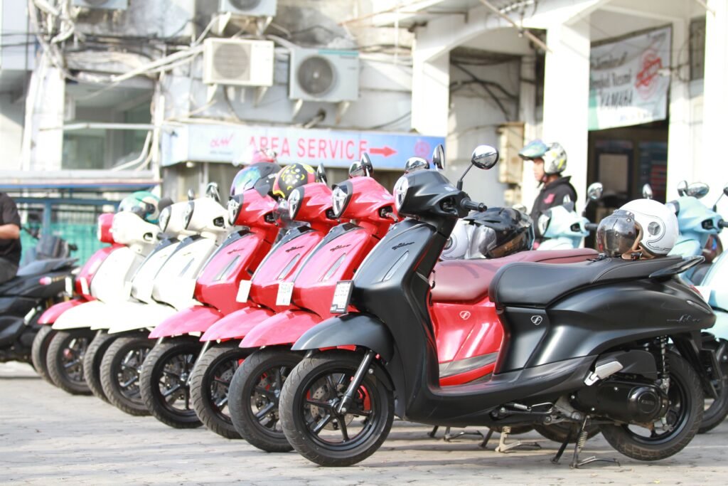 A row of rental scooters lined up outside a rental shop in Bali